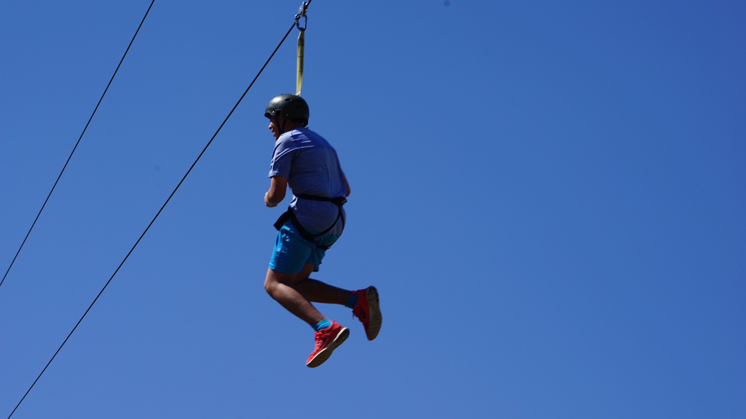 boy swinging through the canyon