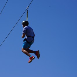 boy swinging through the canyon