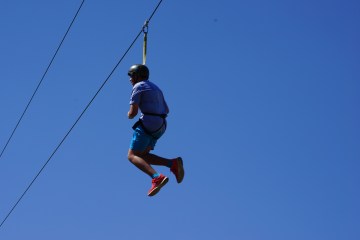 boy swinging through the canyon