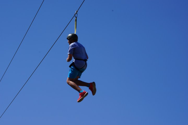 boy swinging through the canyon