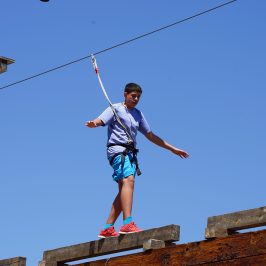 boy balancing on the high ropes course in Lava Zipline Adventure