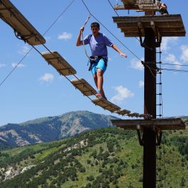 boy working through the high ropes course in Lava Hot Springs