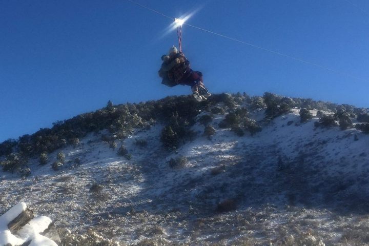 a man flying through the air on a snow covered slope