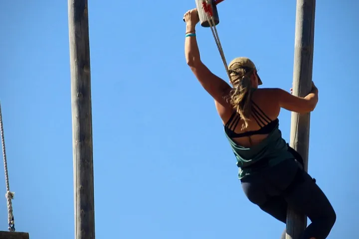 a person hanging from a pole