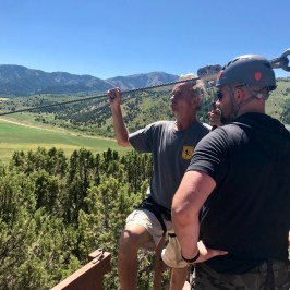 Staff helping get zipliner ready to soar