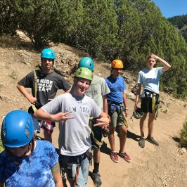 group of boys geared up for the zipline