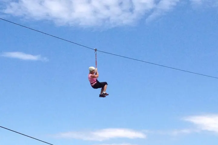 a group of people flying kites in the air