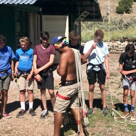 Staff handing out ropes to group of boys