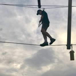 boy tightroping across the high ropes course