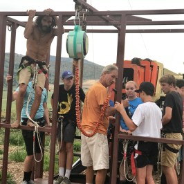 Staff getting group ready to go up on the high ropes course