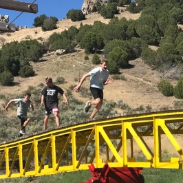 group of friends chasing each other on teeder todder