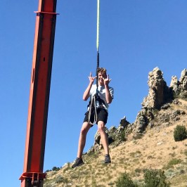 boy coming down from crane in adventure park