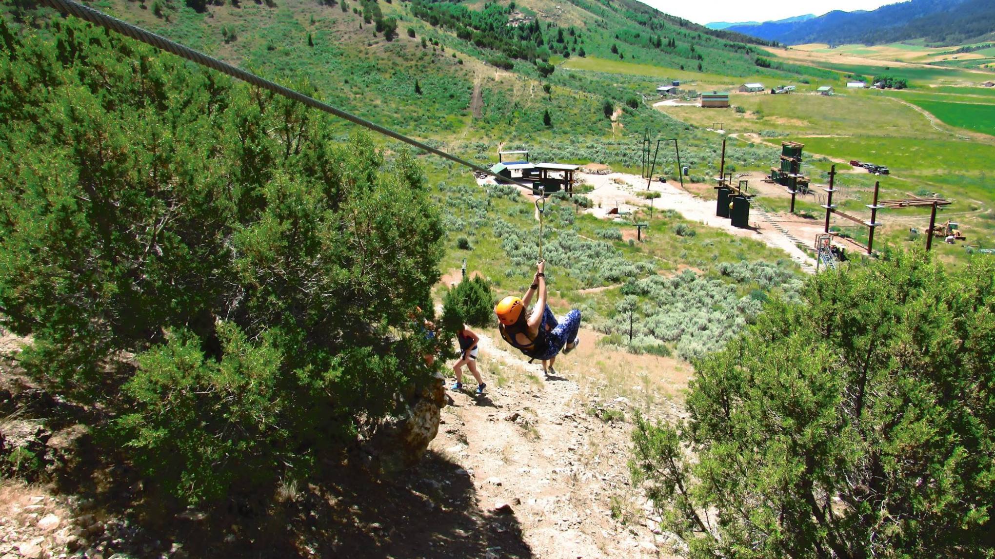 Lady swinging down the zipline in Idaho