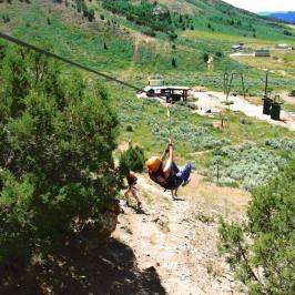 Lady swinging down the zipline in Idaho